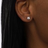 A pair of white gold earrings with diamonds on woman